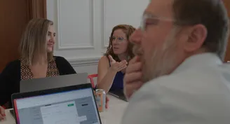 People in a meeting room discussing a project