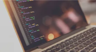 A laptop screen displaying CSS in a code editor.